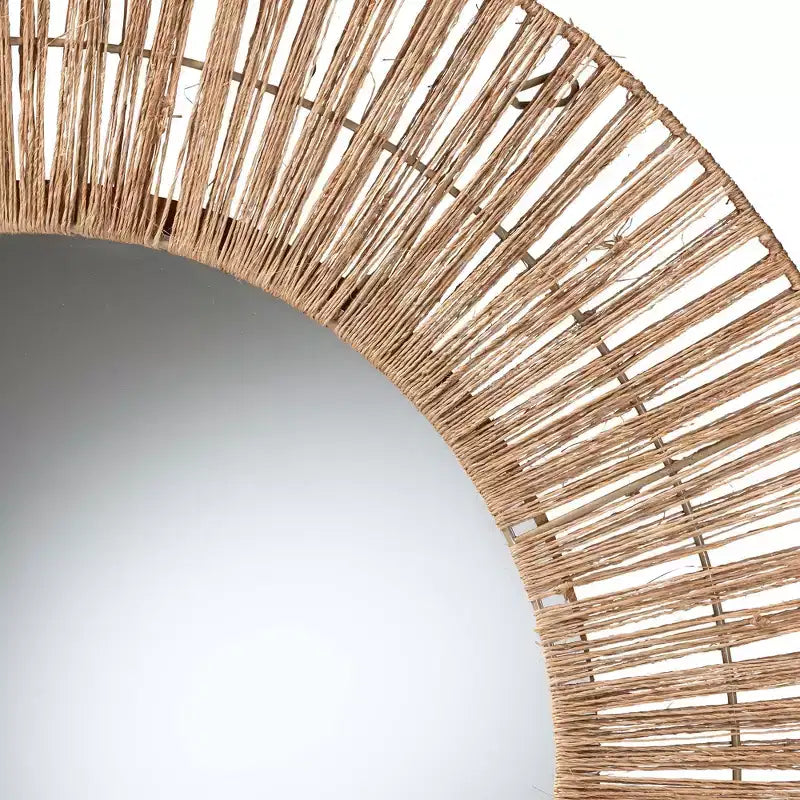 Modern Bohemian-style decorative hanging mirror featuring metal and natural brown seagrass.