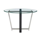 Table à manger avec plateau rond en verre et piètement en acier inoxydable brossé et fer forgé